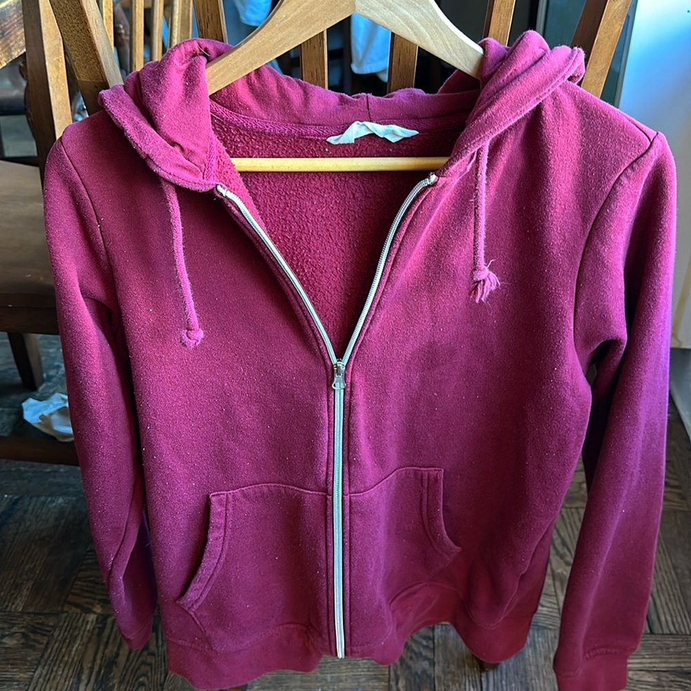 Primark Cares burgundy hoodie with pockets and front zipper. Size small.